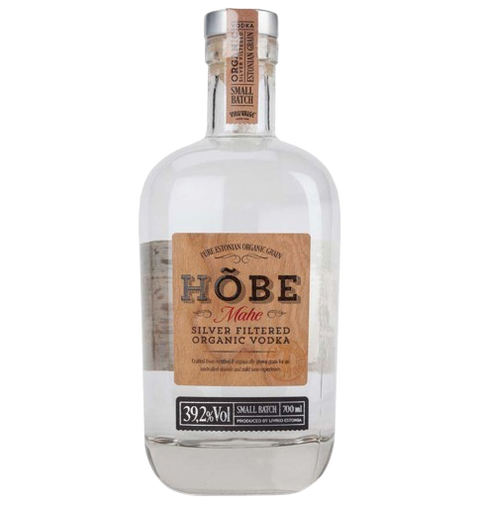 A clear glass bottle containing silver-filtered organic vodka, with a label that reads 'HÙBE MAHE' and indicates the volume of 39.2% ABV.